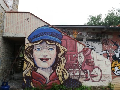 Mural portraying a partisan messenger Street Art by Chus for Agripunk Onlus in Ambra Toscana Italia