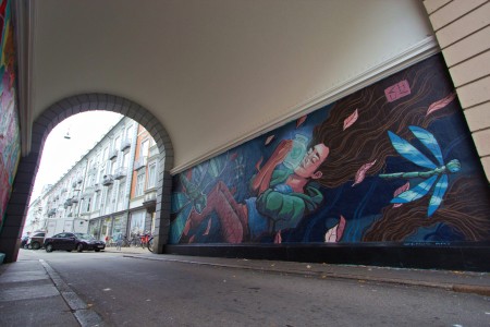 angle view of Mural with a Girl a glowy jar dragonflies and leaves Street Art by Chus for Westend Walls in Copenhagen
